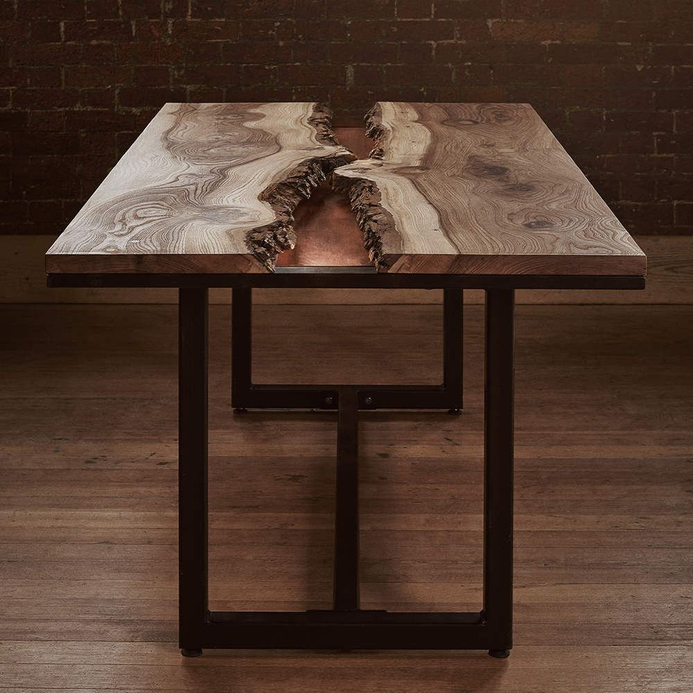 End view of the elm and copper live edge dining table with industrial black steel legs