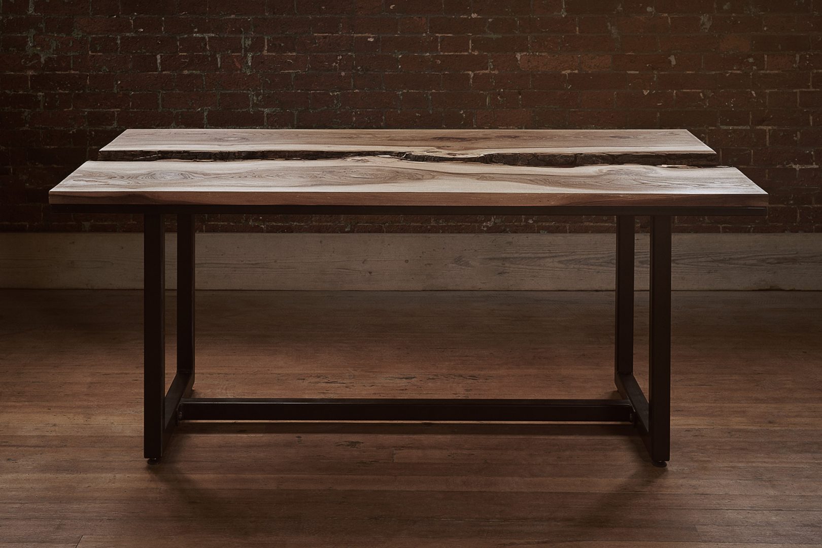 Side view of the elm and copper live edge dining table with industrial black steel legs