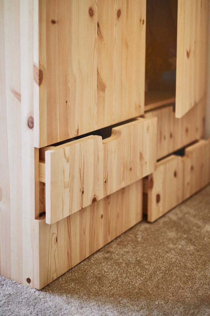 Close up view of the pine wardrobe and drawer of the children's house beds
