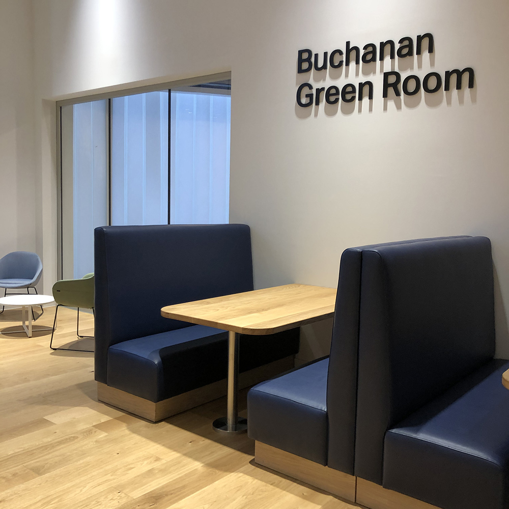 table and blue leather booth seating in the Buchanan Green Room