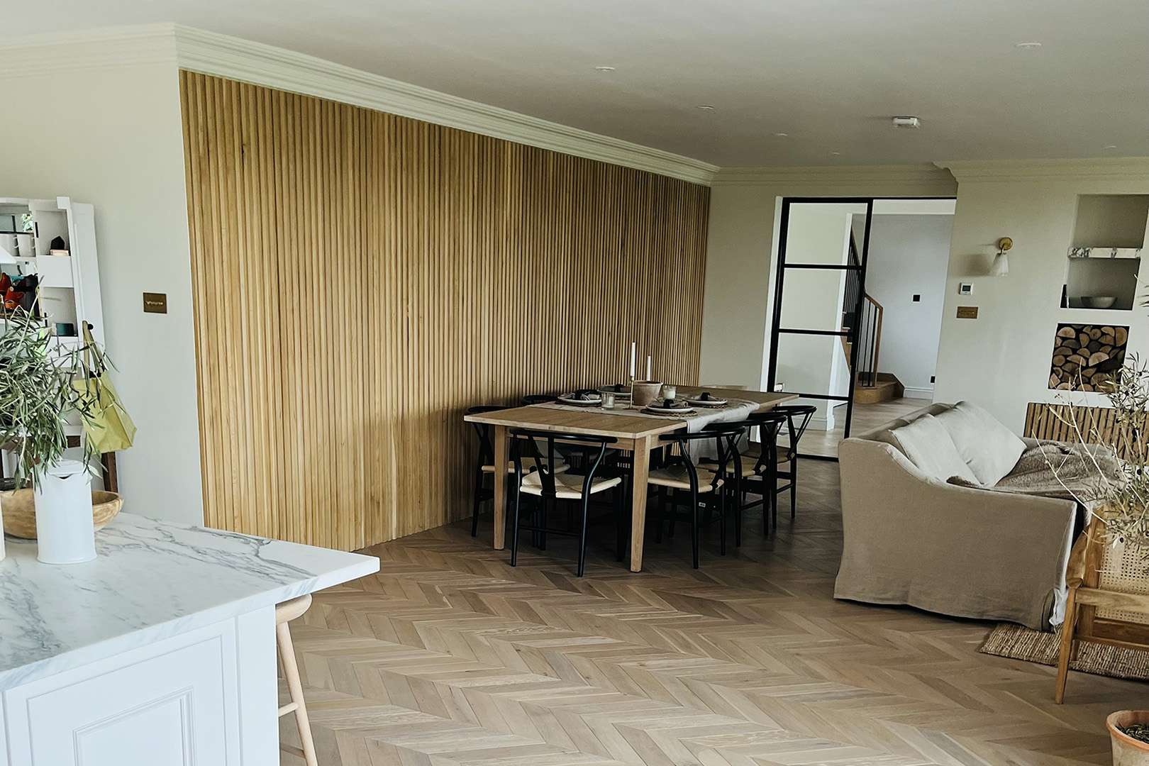 Oak slat wall in open plan kitchen dining room in luxury home