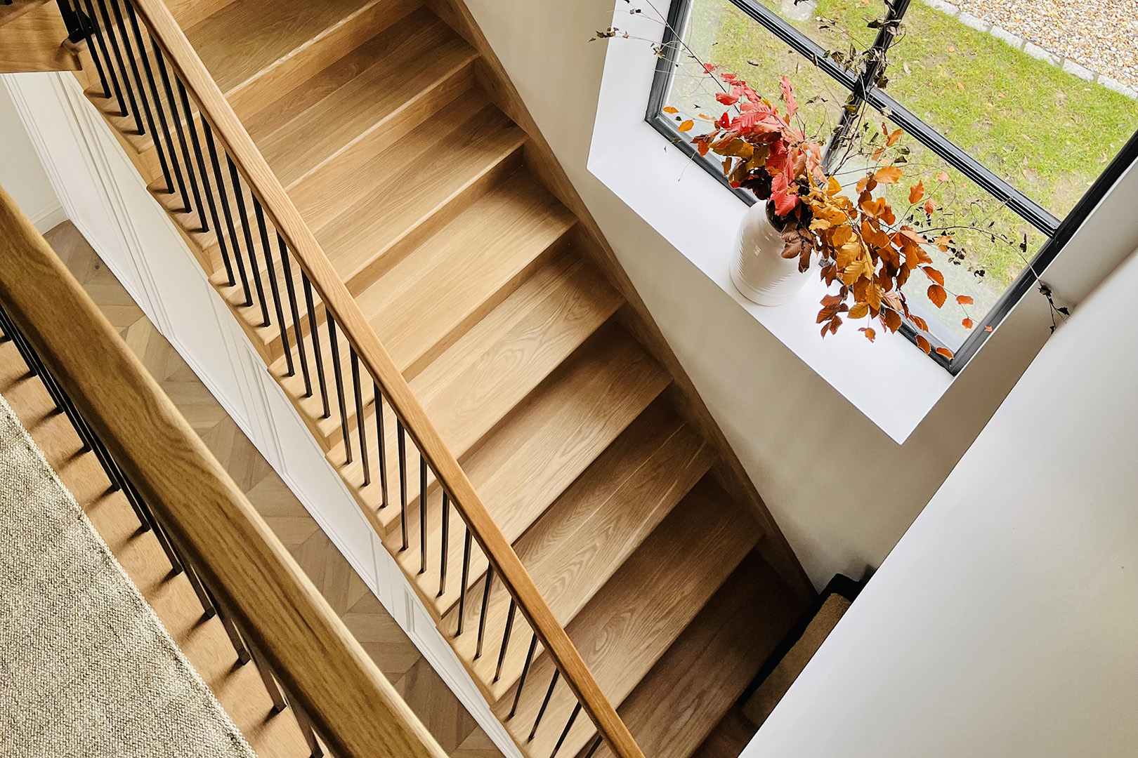 birds eye view of oak staircase with black steel balustrade and oak handrail