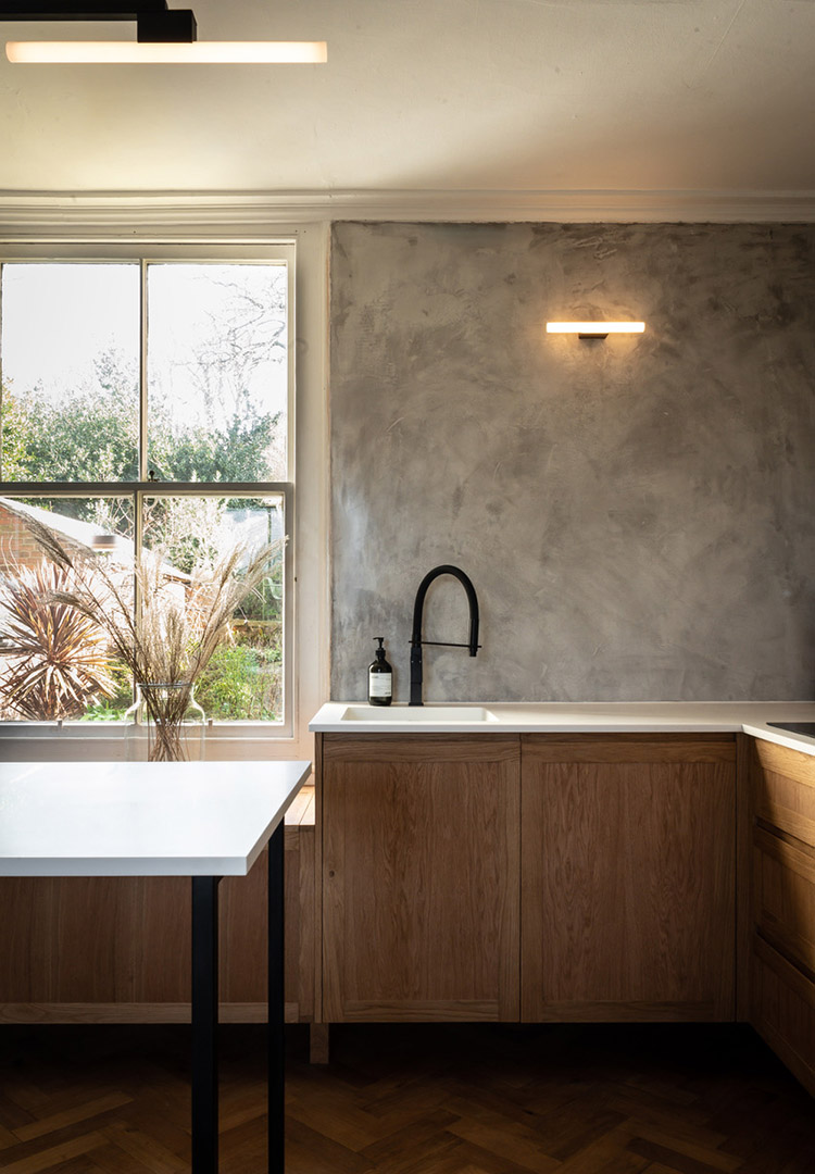 shaker oak kitchen cupboard doors with polished plaster walls and minimalist black tap