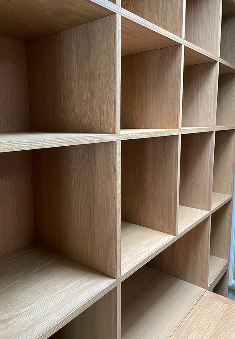 close up of the pigeon hole style shelves of the modern oak kitchen dresser