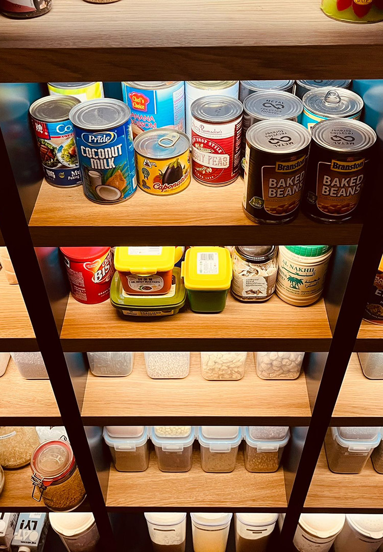 kitchen pantry oak shelves with tins and food items