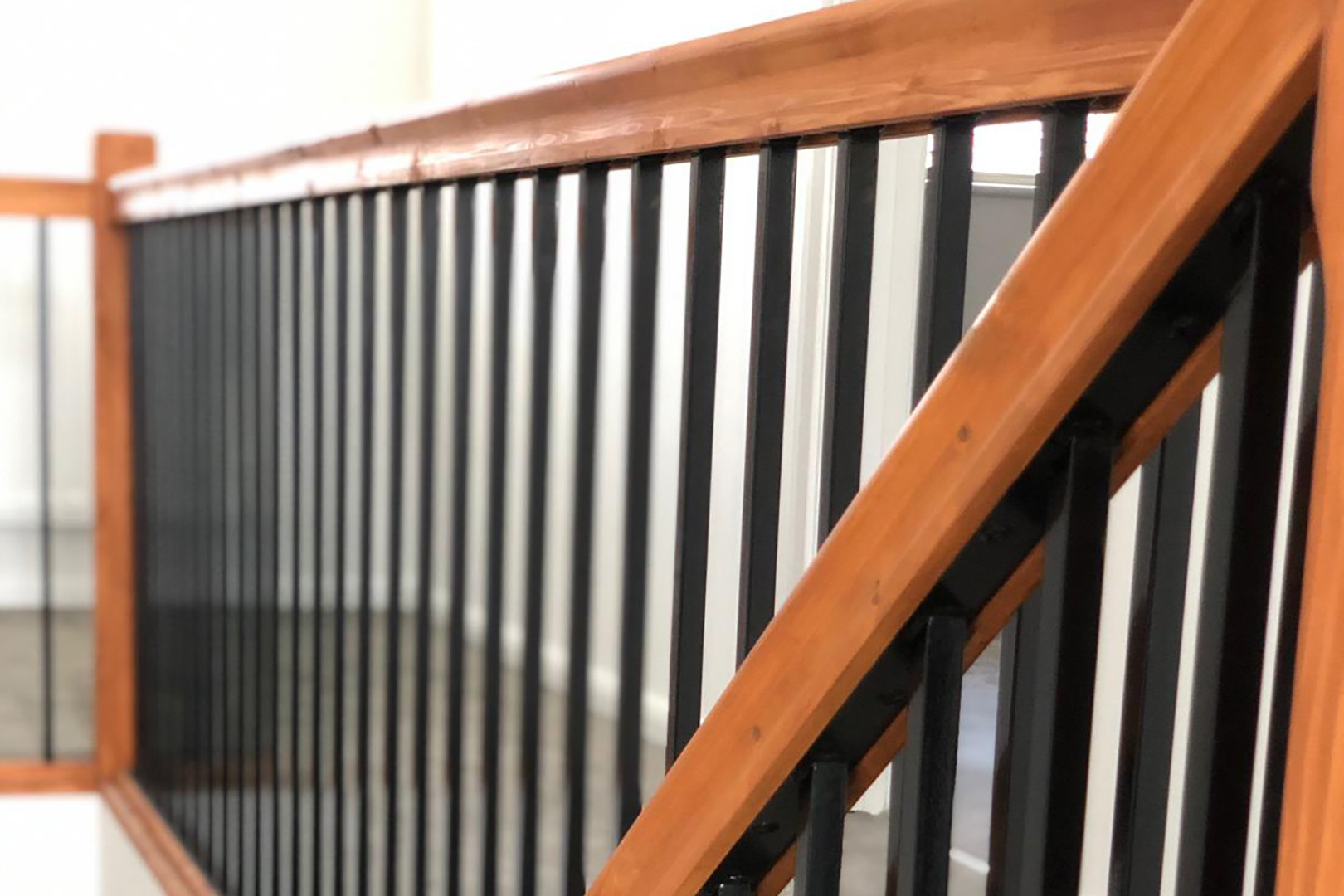 steel balustrade with vertical steel spindles and a stained softwood handrail
