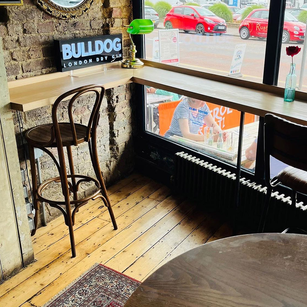 Bar furniture high L shaped Beech window table with stools and view out of the window