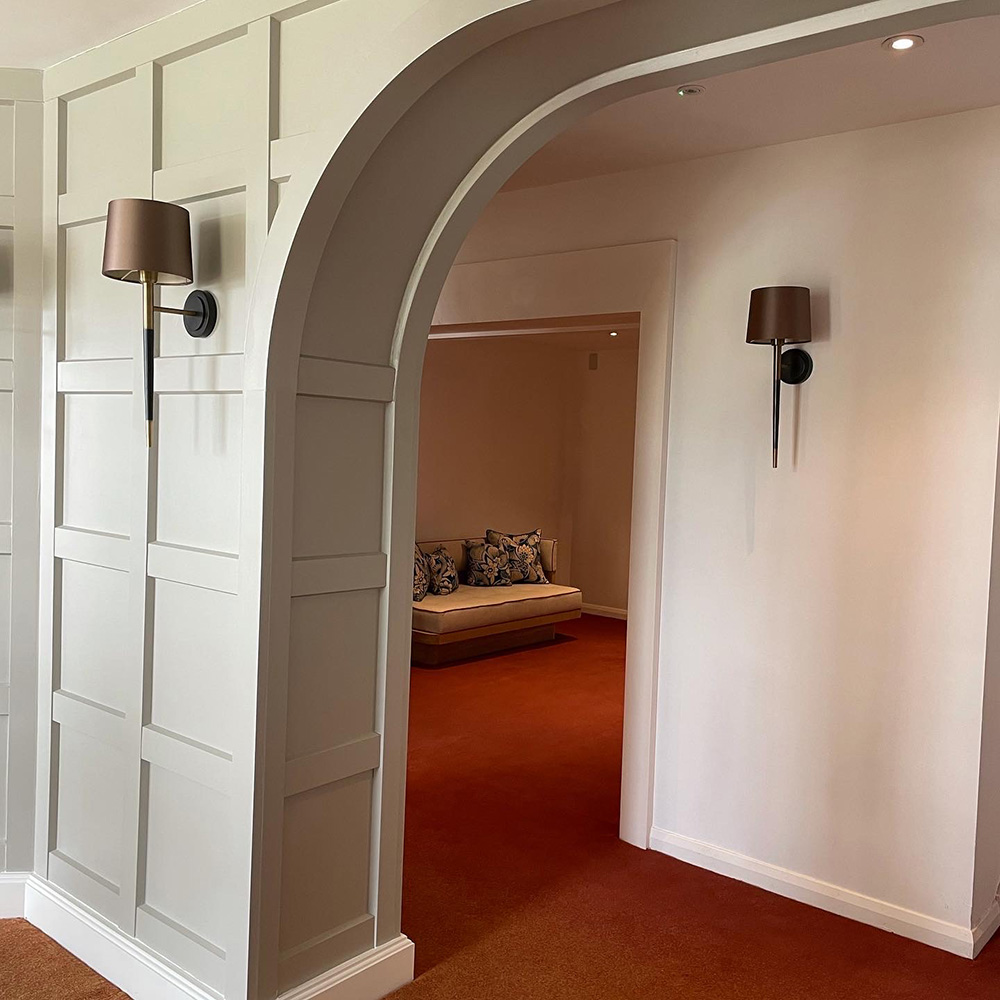 Close view of panelled arch and wall light at the relais cooden beach hotel