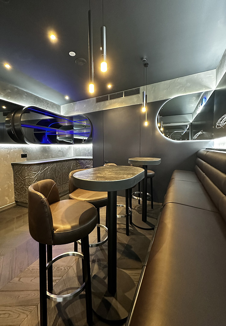 leather banquette, high tables and bar stools in the executive box emirates