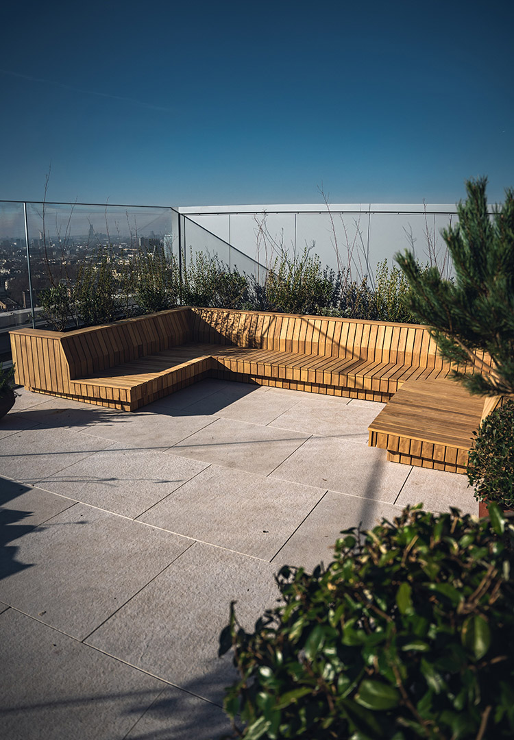 Iroko terrace furniture on a London rooftop with plants surrounding