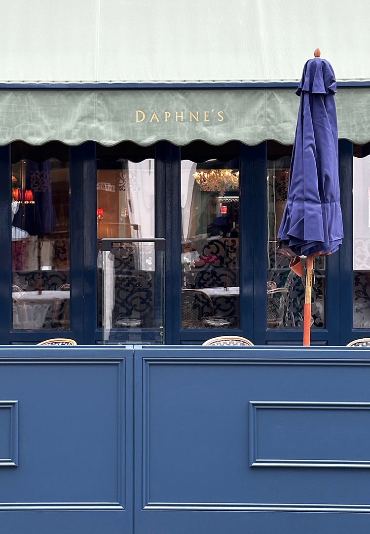 A close up view of the frontage and outdoor seating area of Daphne's restaurant in London Kensington