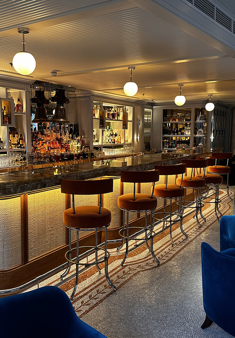 First Floor bar at Gaia, London with wicker panels and orange bar stools